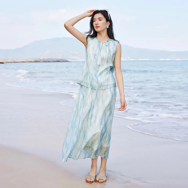 Watercolor floral print Lyocell set for women, featuring a sleeveless gathered top with a tie neckline and a flared midi skirt in blue and white hues. — From Borcelleclothes.