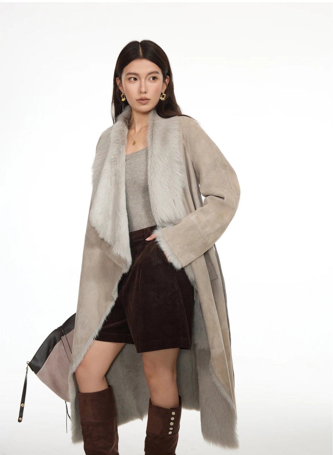 Unfastened Neutral Intrigue coat with model’s hand in shorts pocket, showing relaxed styling — From Borcelleclothes.