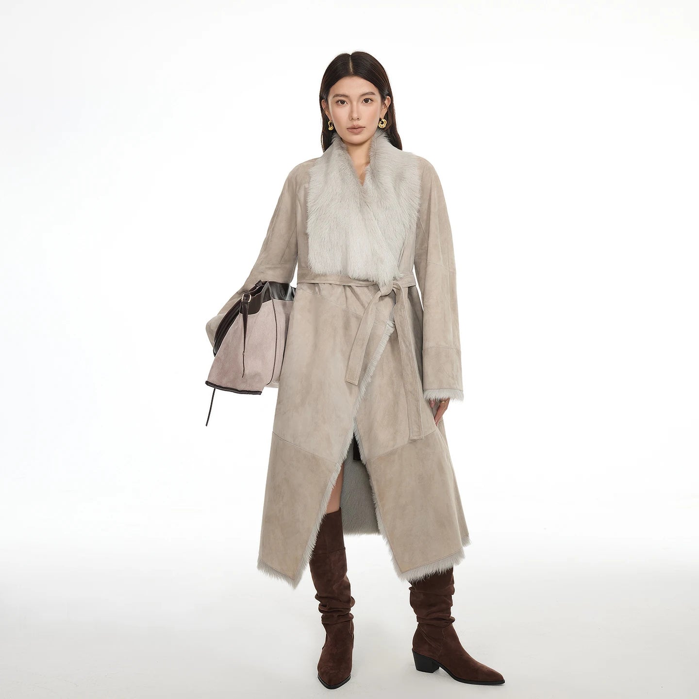 Women's wide lapel double-faced goatskin coat in Neutral Intrigue, with uncut edges and flowing fur, belted at the waist — From Borcelleclothes.
