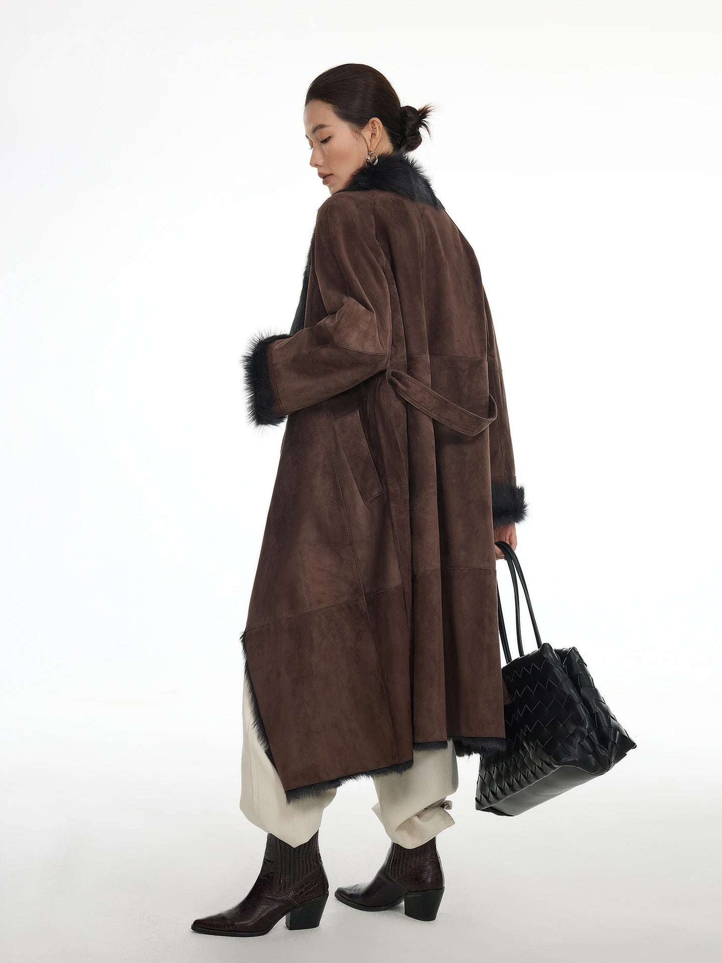 Back view of the Raw Umber goatskin coat, showing the coat’s length and belt placement — From Borcelleclothes.