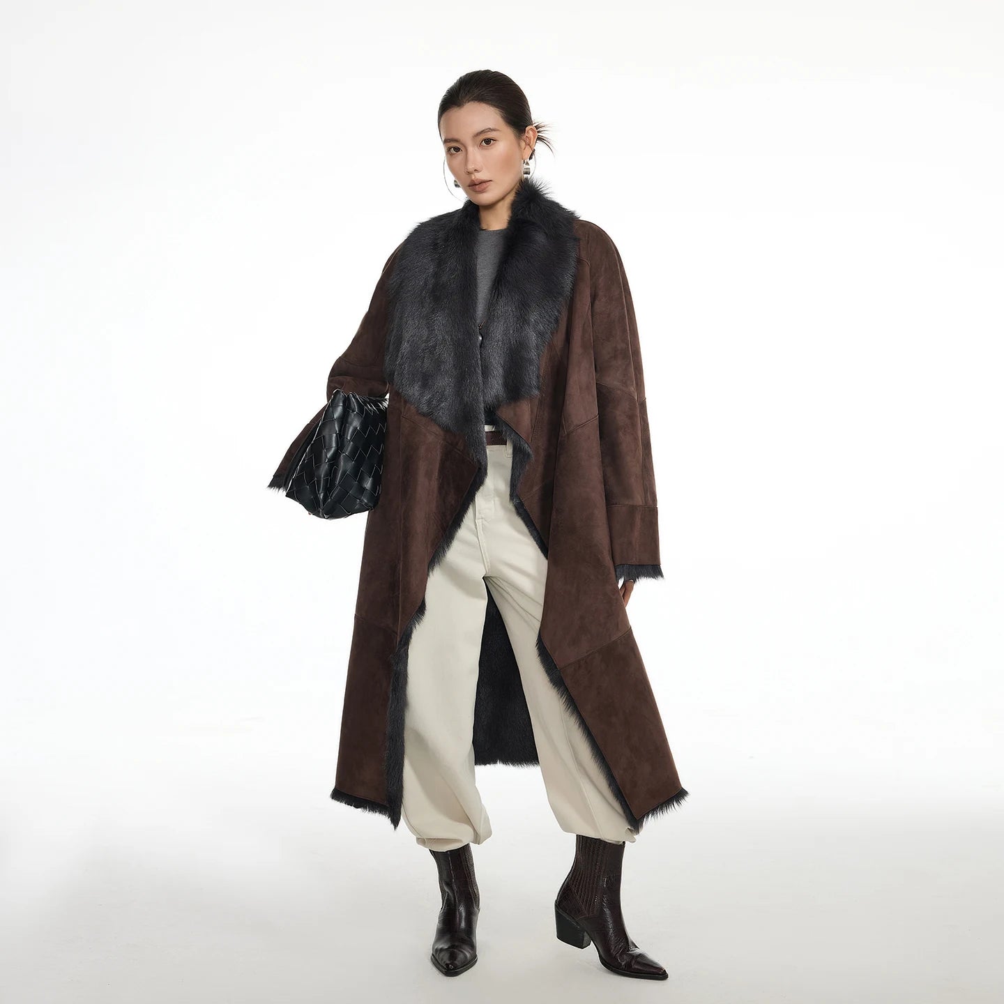 Women's wide lapel double-faced goatskin coat in Raw Umber, with uncut edges and flowing fur, belted at the waist — From Borcelleclothes.