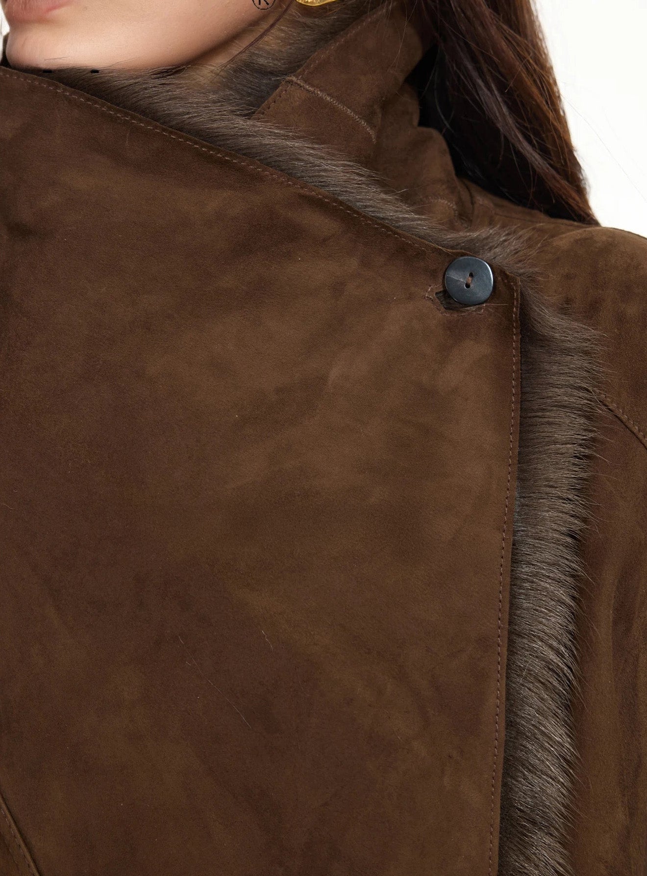 Close-up of fastened collar on the Woodsy Brown wide-lapel goatskin coat, highlighting the double-faced construction — From Borcelleclothes.