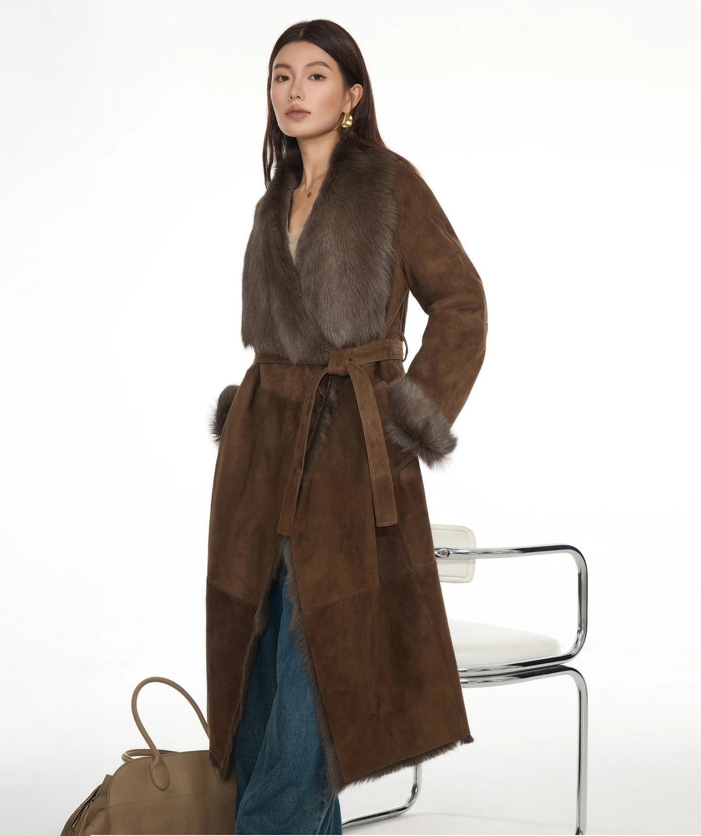 Model with hands in pockets, wearing the wide-lapel goatskin coat in Woodsy Brown — From Borcelleclothes.
