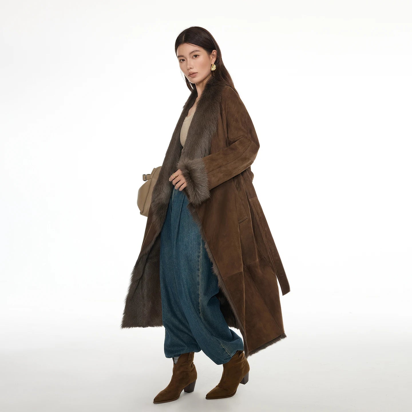 Women's wide lapel double-faced goatskin coat in Woodsy Brown, with uncut edges and flowing fur, belted at the waist — From Borcelleclothes.