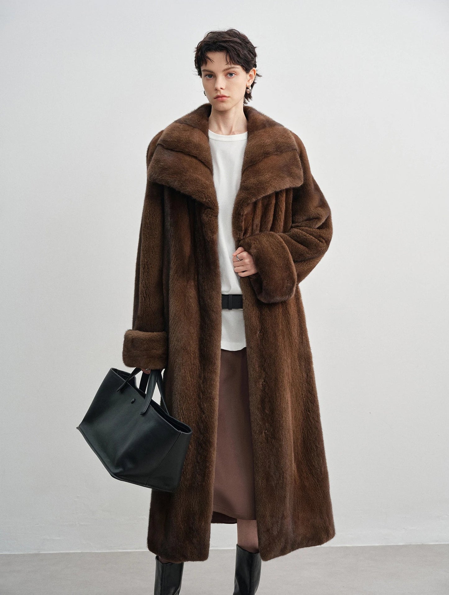 Model holding a handbag in the brown mink coat — From Borcelleclothes.