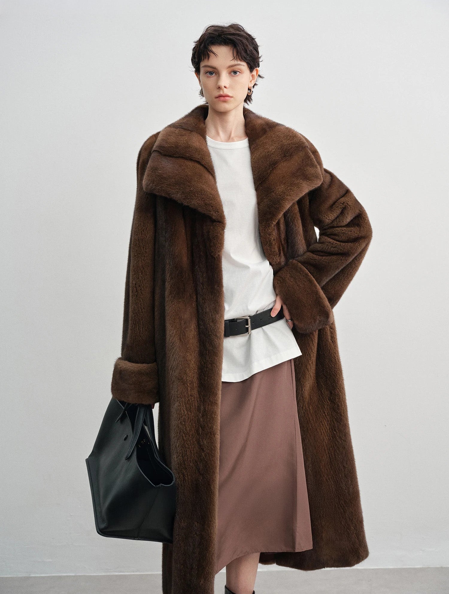 Unfastened brown mink coat with model's hand resting at the waist — From Borcelleclothes.