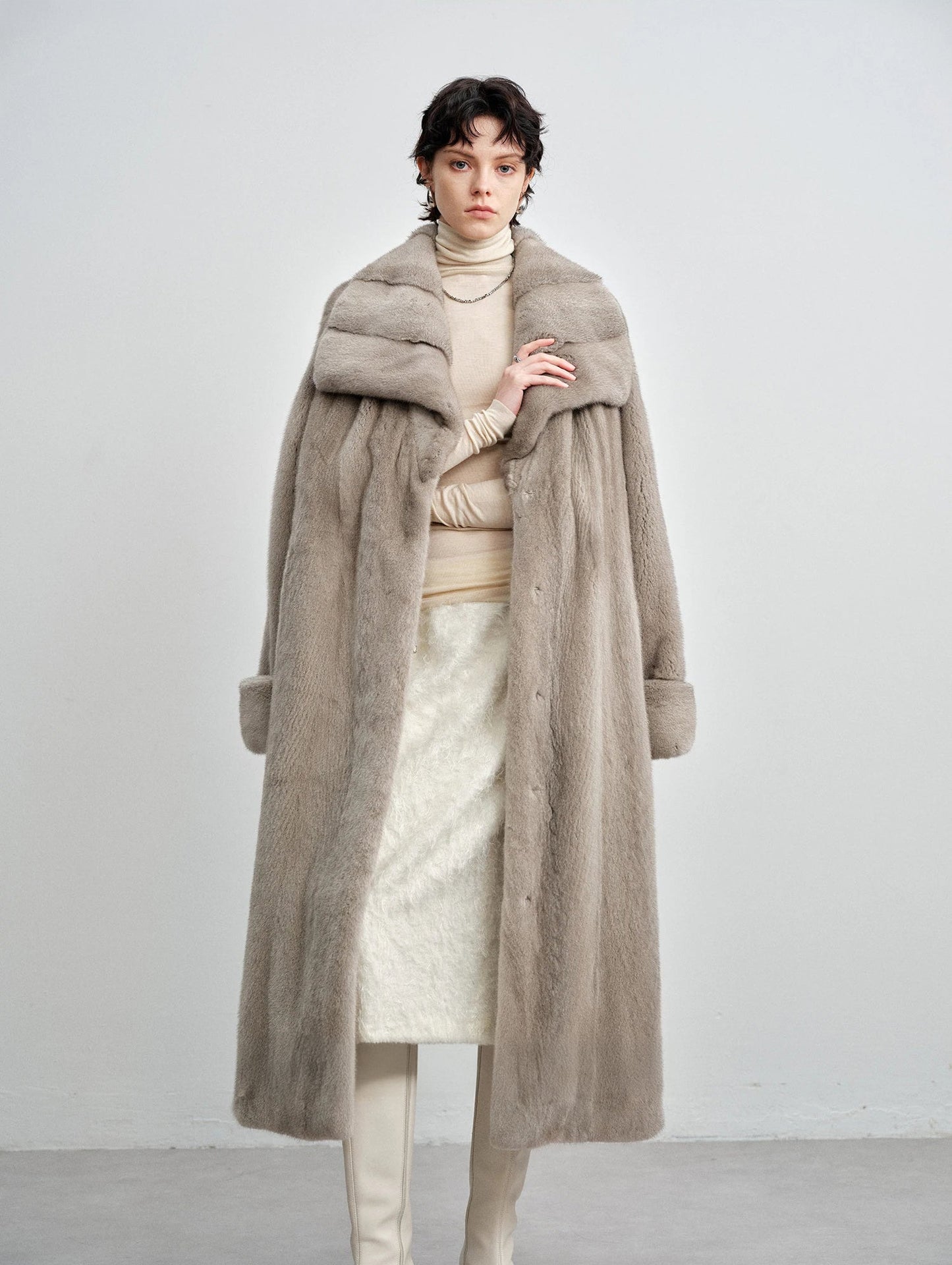 Model draping the silver blue mink coat over her shoulders — From Borcelleclothes.