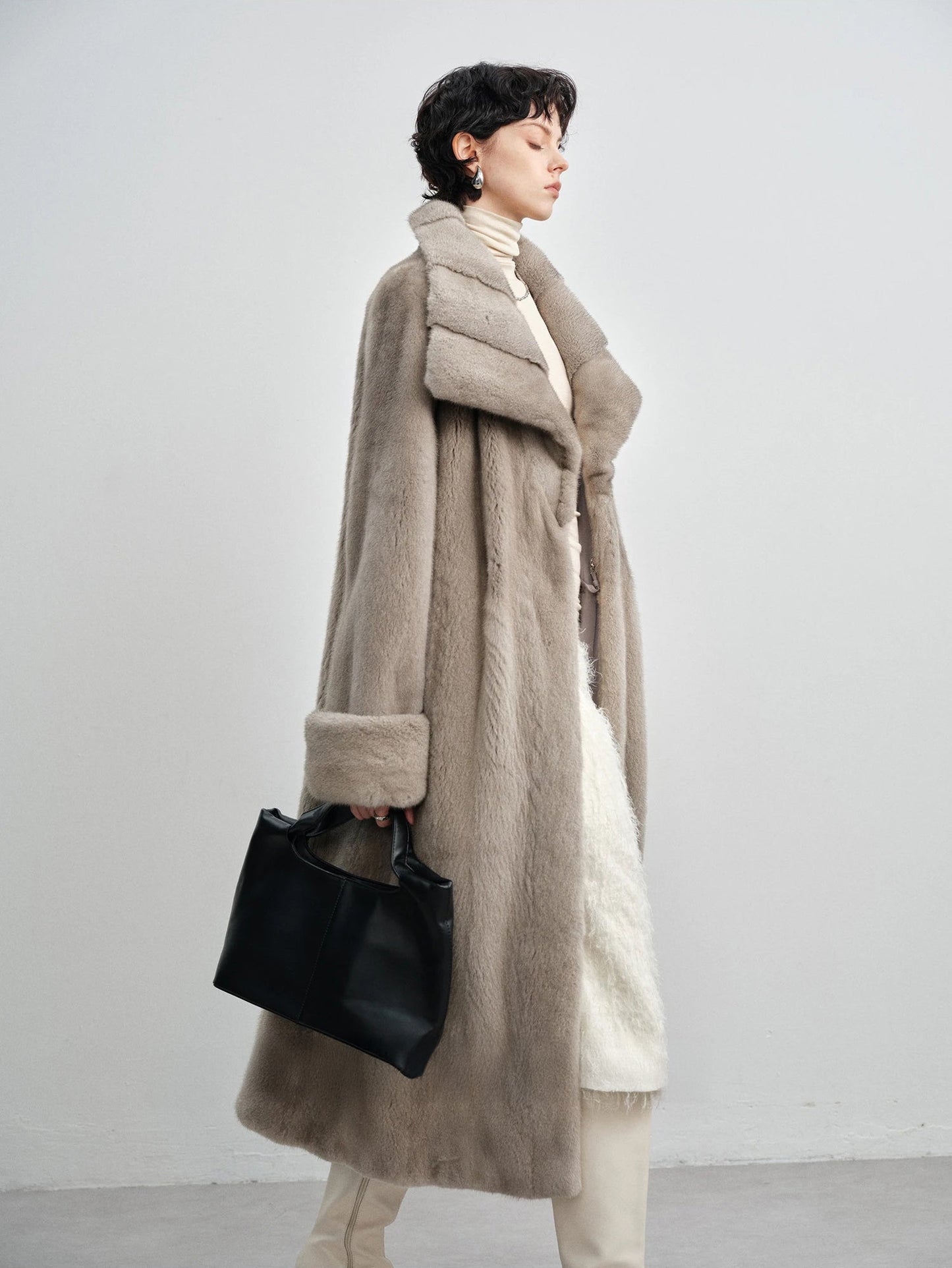Model walking in profile view wearing the wide lapel silver blue mink coat — From Borcelleclothes.