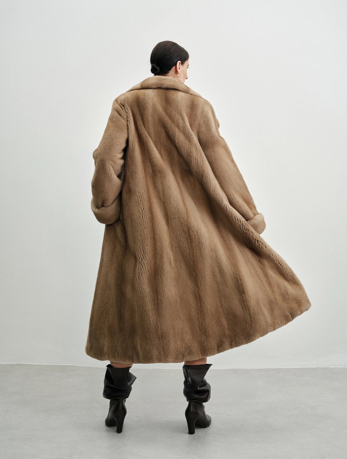 Back view of the model in the striped mink coat — From Borcelleclothes.