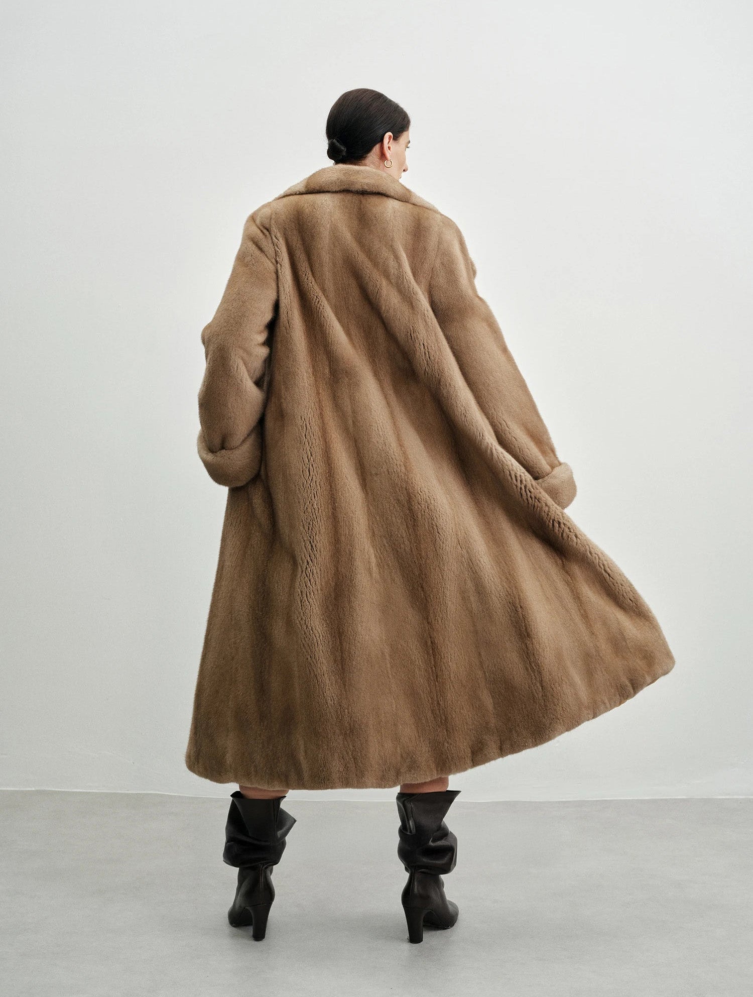 Back view of the model in the striped mink coat — From Borcelleclothes.