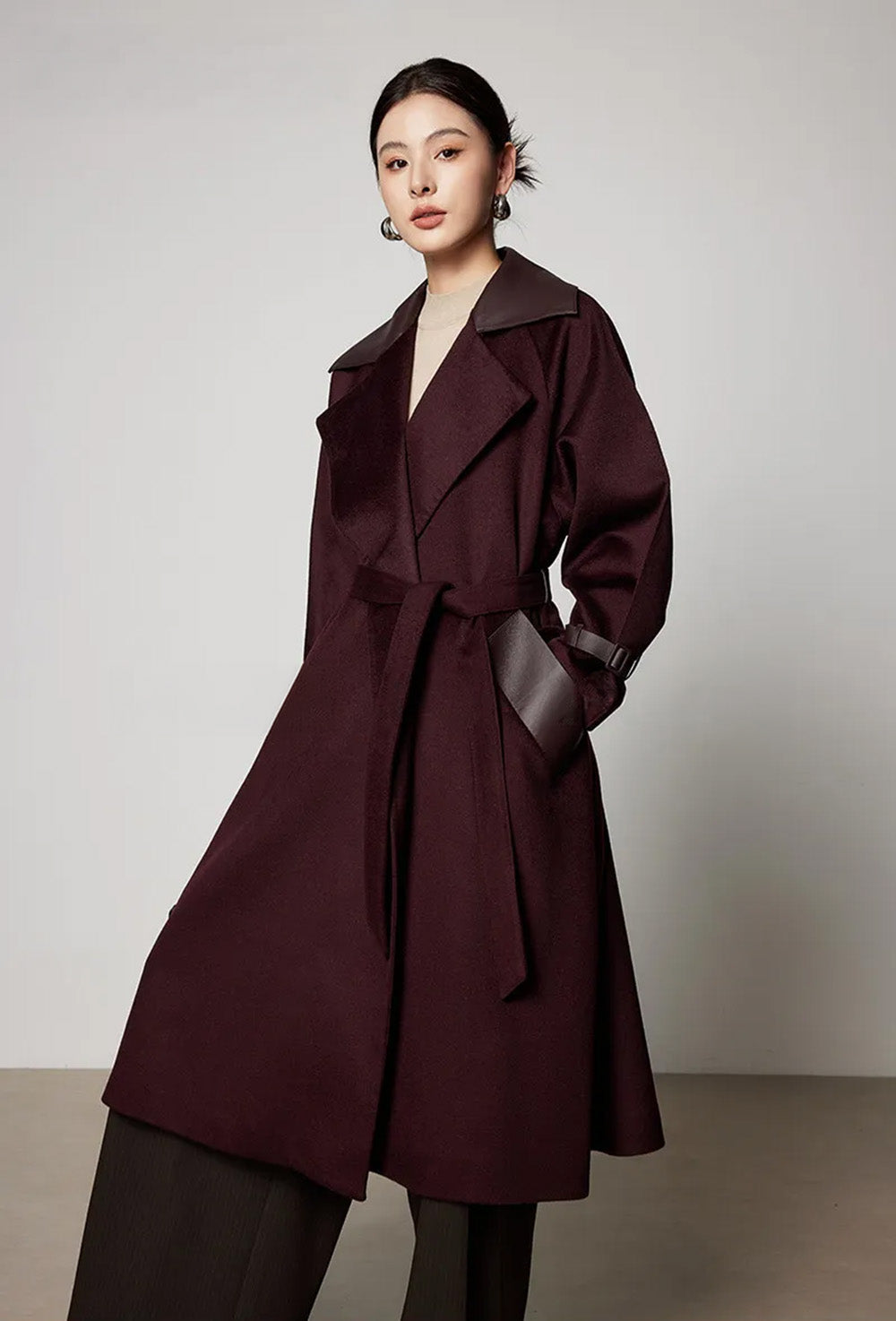 Model with a hand in the wide single-welt side pocket, displaying the structural detail and wool finish. From Borcelleclothes.