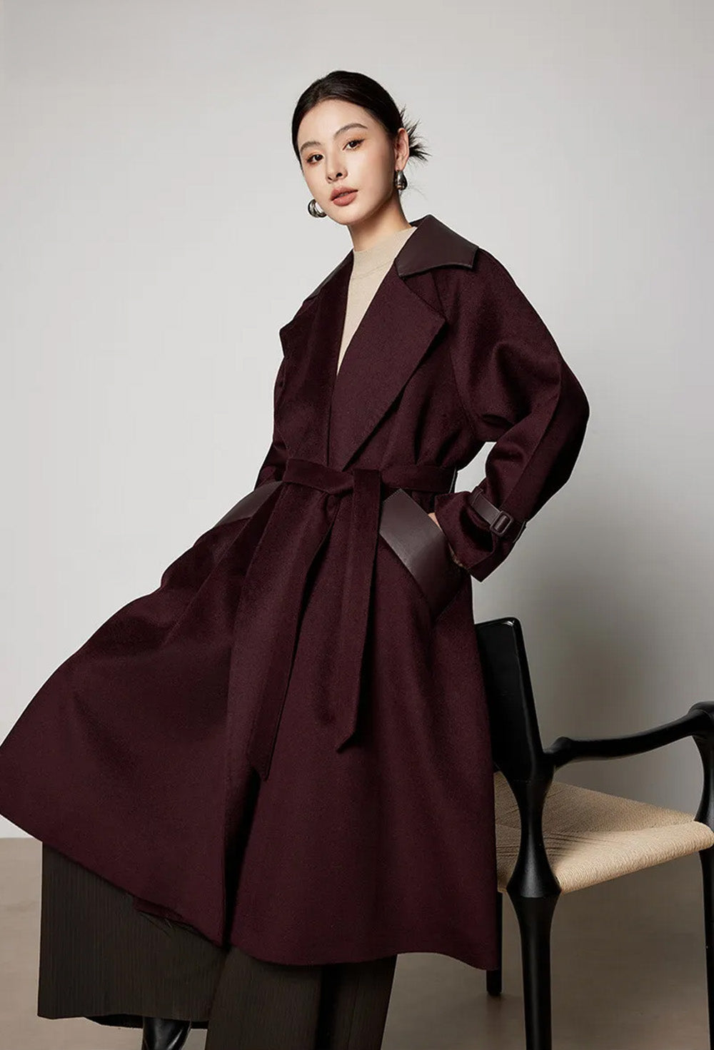 Model leaning back in a chair, showcasing the relaxed fit and the luster of the sheepskin upper collar under light. From Borcelleclothes.