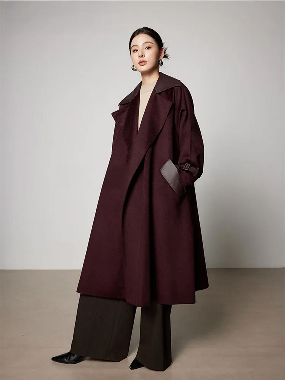 Unfastened Dégustation coat with a hand in the pocket, revealing the clean lines and internal structure. From Borcelleclothes.