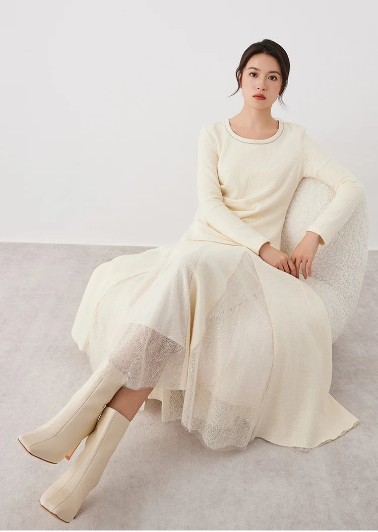 Model sitting in an armchair wearing a women's wool godet skirt with sheer panels in Godet Summer — From Borcelleclothes.