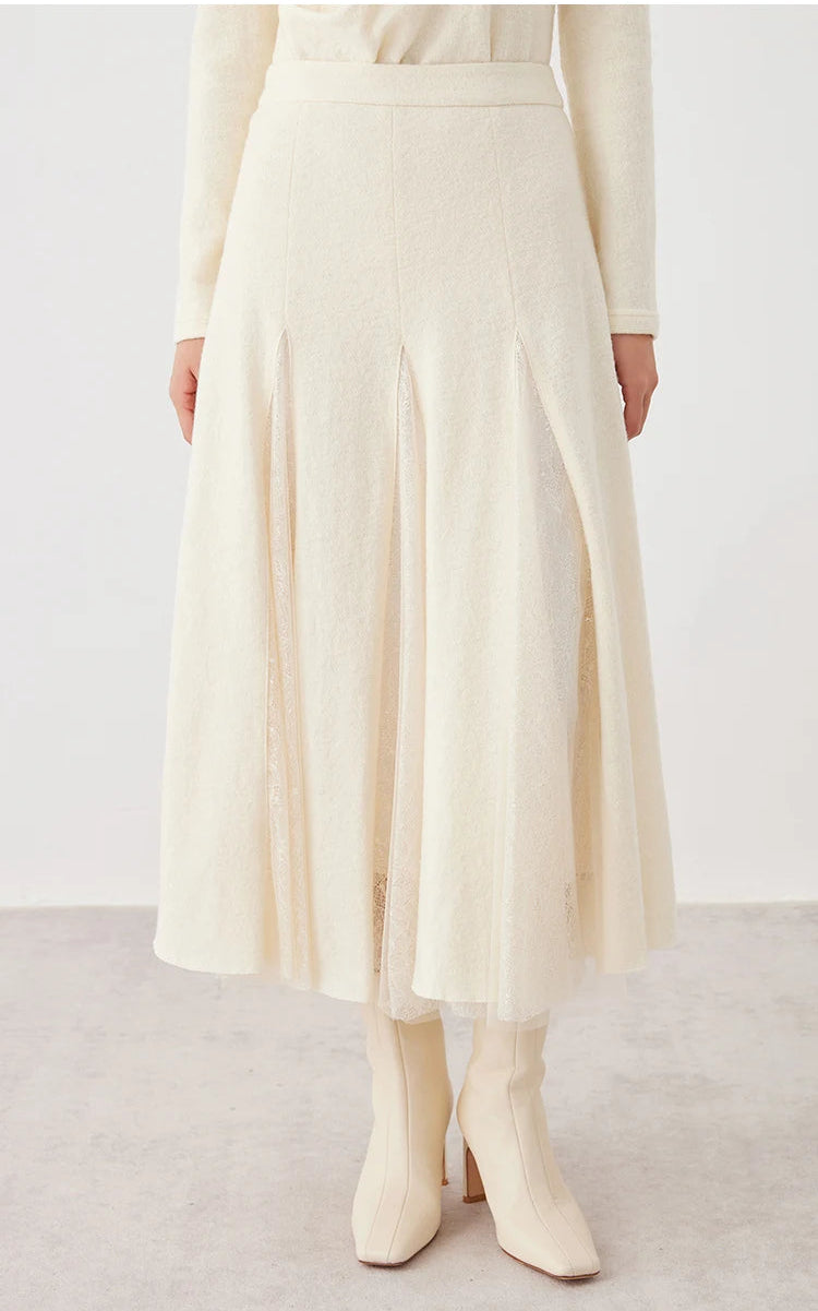 Full-length view of a model standing with hands at her sides in a women's wool godet skirt with sheer panels in Godet Summer — From Borcelleclothes.