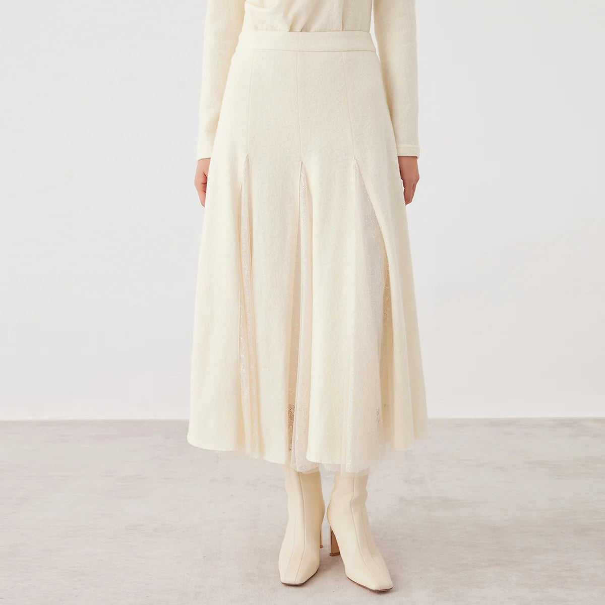 Women's mid-calf merino wool blend godet skirt in Godet Summer. Structural wool panels open into fluid, sheer mesh inserts overlaid with lace. — From Borcelleclothes.