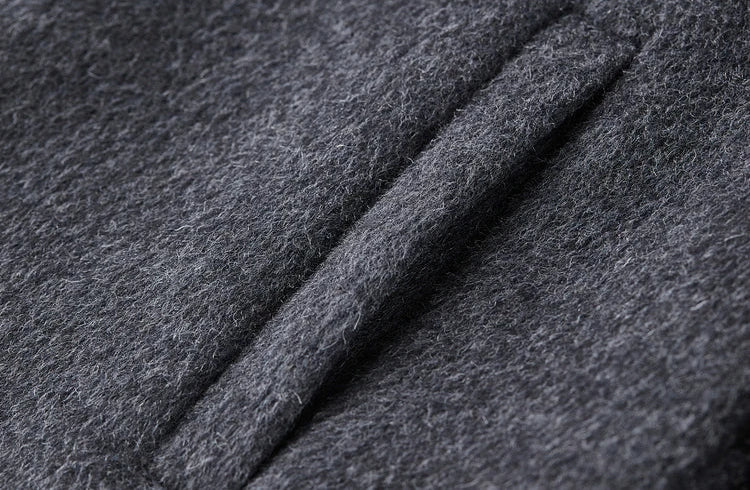 Detail of the clean, single-welt side pocket on the dense grey wool fabric — From Borcelleclothes.