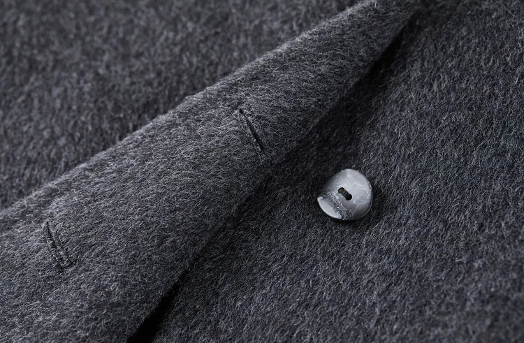 Close-up of the meticulous finished buttonhole and unfastened button on the grey jacket — From Borcelleclothes.