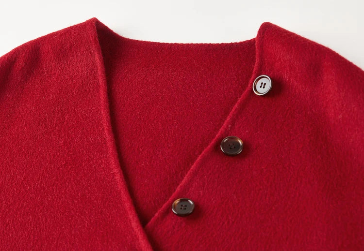 Close-up of the deep V-neckline against the fiery red double-sided wool — From Borcelleclothes.