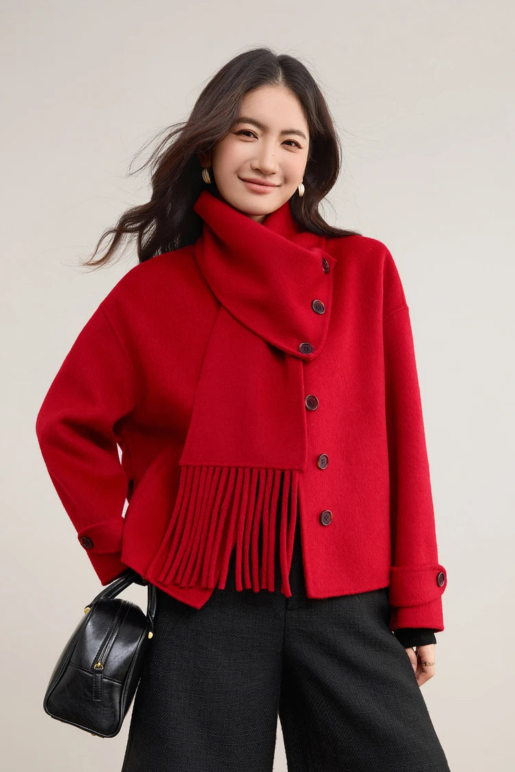 A woman in a vibrant red wool jacket walking with her bag, the scarf adding a layer of texture — From Borcelleclothes.
