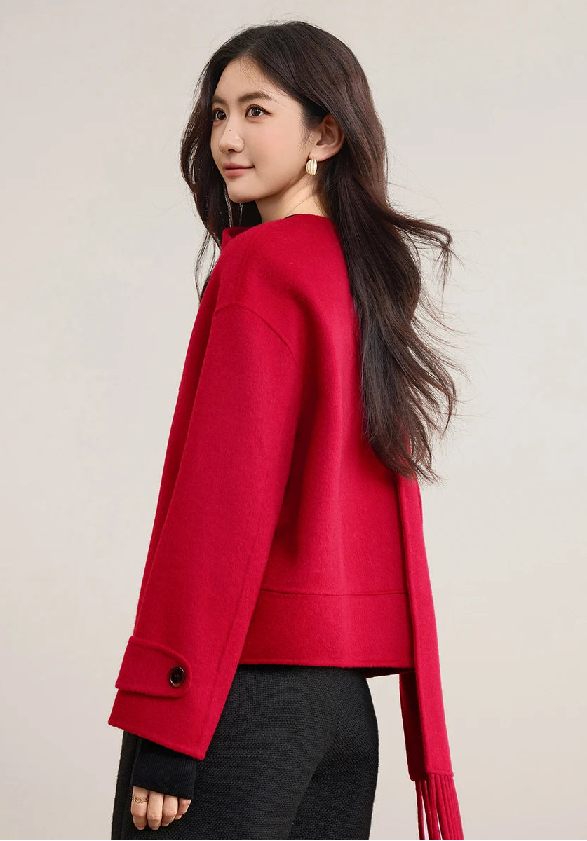 Side profile of a woman showcasing the oversized silhouette of the red wool jacket and scarf — From Borcelleclothes.