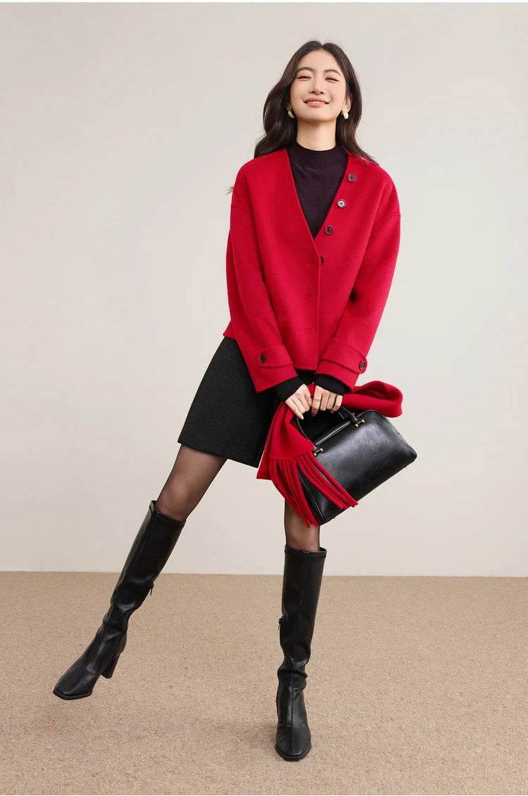 An energetic, playful pose of a woman showing the mobility and lightness of the structured red wool — From Borcelleclothes.
