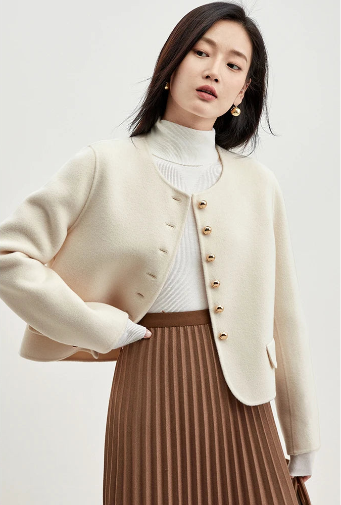Woman wearing an unfastened Echo of Jazz jacket with her hand on her waist, showcasing a relaxed yet sophisticated silhouette — From Borcelleclothes.