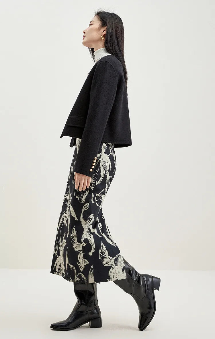 Side view of a woman in a black double-sided wool jacket, highlighting the bold contrast of gold on noir — From Borcelleclothes.