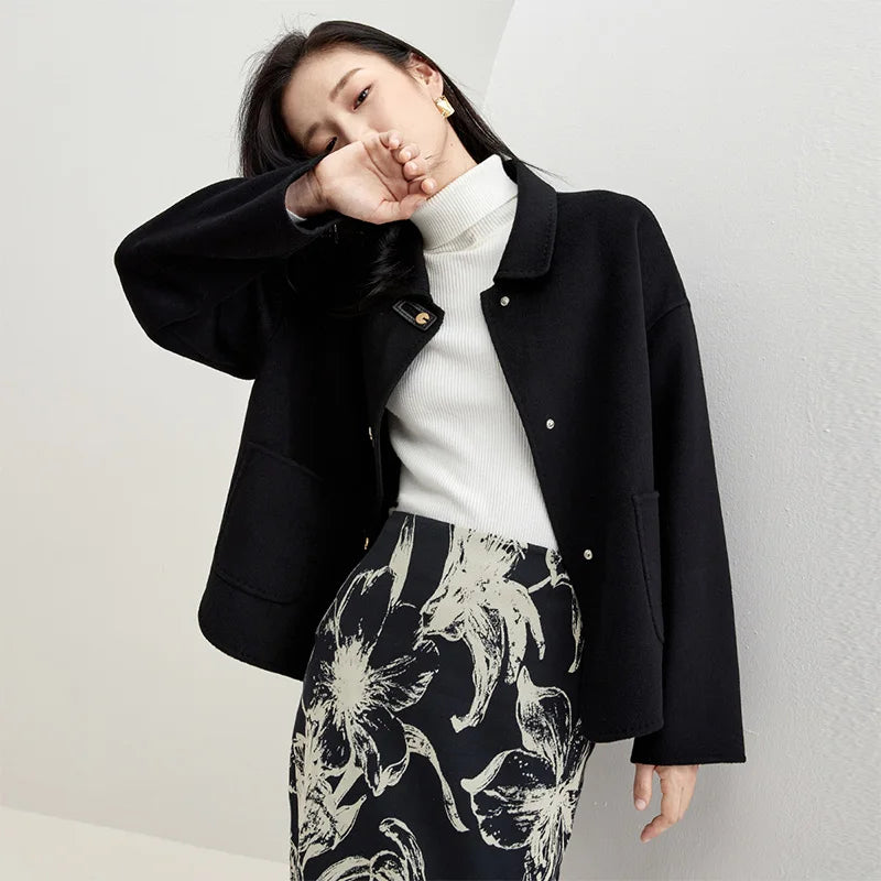 Women's double-sided wool jacket in Black Cat color, featuring decorative rectangular loops, golden C-shape snaps, and a softly arched side hem. — From Borcelleclothes.