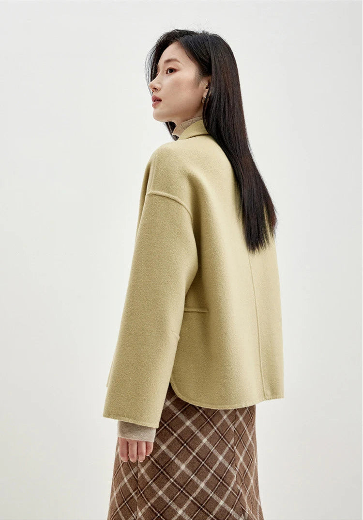 Back view of a woman wearing a wool jacket with graphic loop detail in Willow Catkin — From Borcelleclothes.