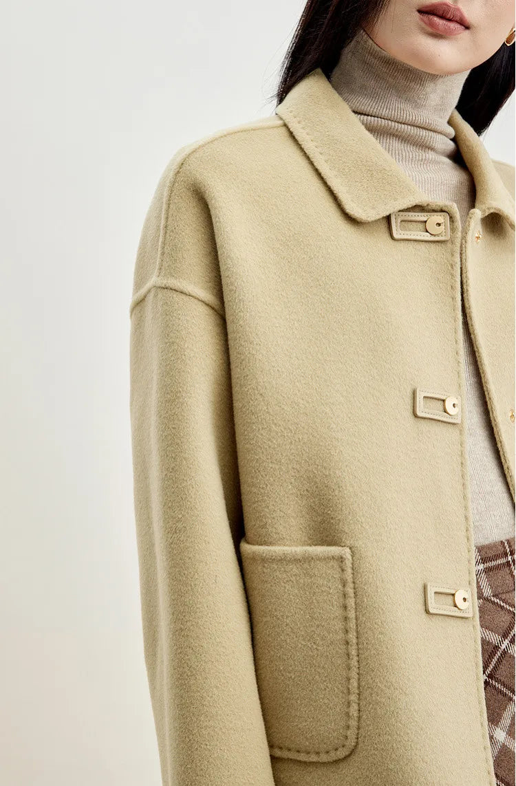 Upper section view of a model in a women's wool jacket with graphic loop detail — From Borcelleclothes.