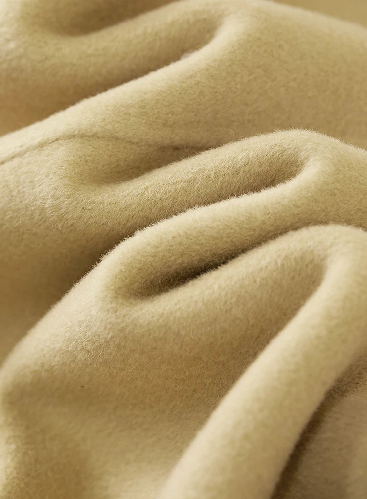 Wave-folded texture of a women's wool jacket with graphic loop detail in Willow Catkin — From Borcelleclothes.