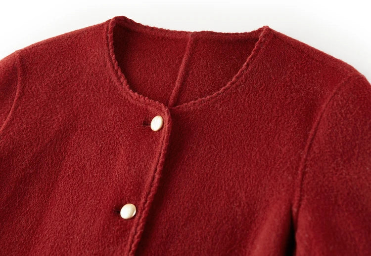 Close-up of the Betta Crimson wool jacket’s round neckline, highlighting the meticulous hand-made Wave Stitch. — From Borcelleclothes.
