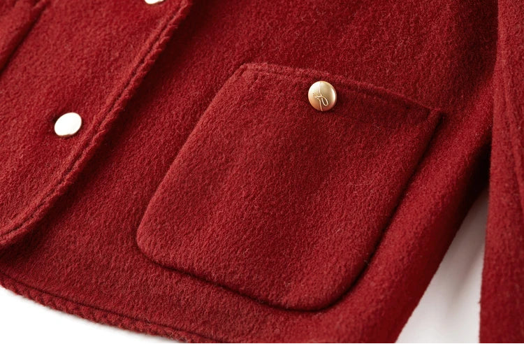 Close-up of a side patch pocket on the Betta Crimson wool jacket, adorned with a matching decorative button. — From Borcelleclothes.