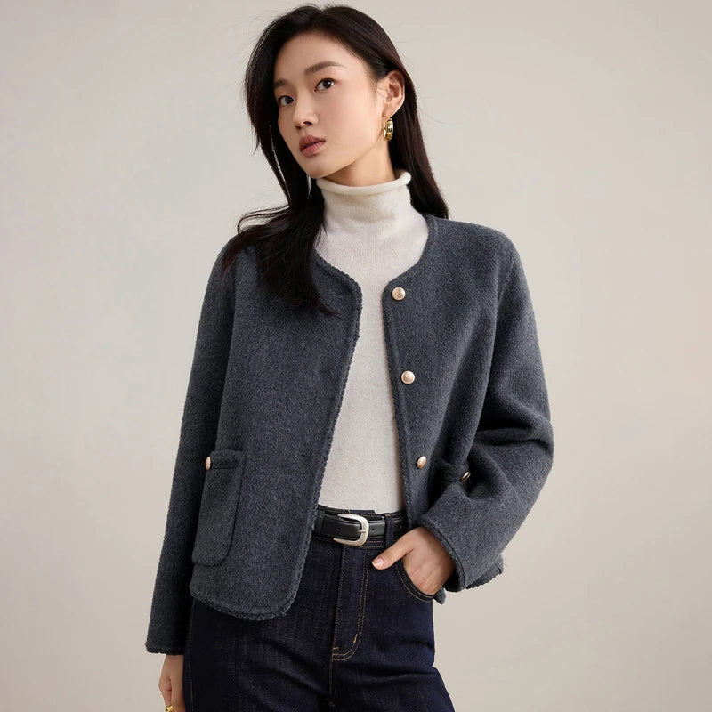 Women's double-sided virgin wool jacket in Perle Noir. Features include gold-tone embossed buttons, patch pockets, and hand-made Wave Stitch finishing along the edges. — From Borcelleclothes.