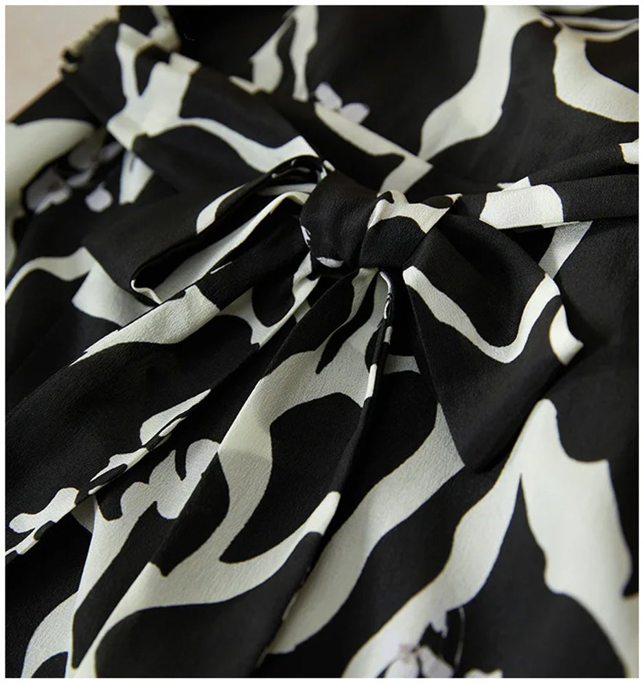 The intricate sash system of the wrap dress, showing how the silk ribbons secure the waist for a tailored, individual fit. — From Borcelleclothes.