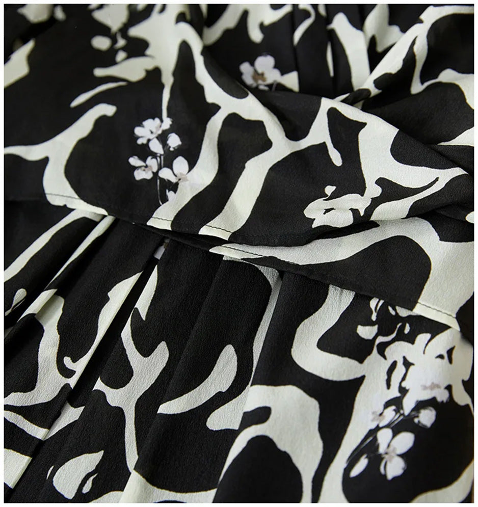 Close-up of the front box pleats on the skirt, where the architectural fold creates a vertical rhythm amidst the "Rorschach" print. — From Borcelleclothes.