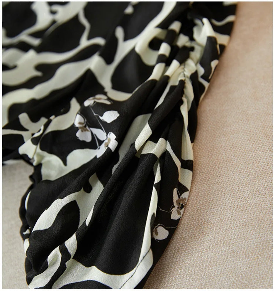Detail of the vertical gathered cuffs on the 1/3 sleeves, adding a touch of femininity to the bold, abstract print. — From Borcelleclothes.