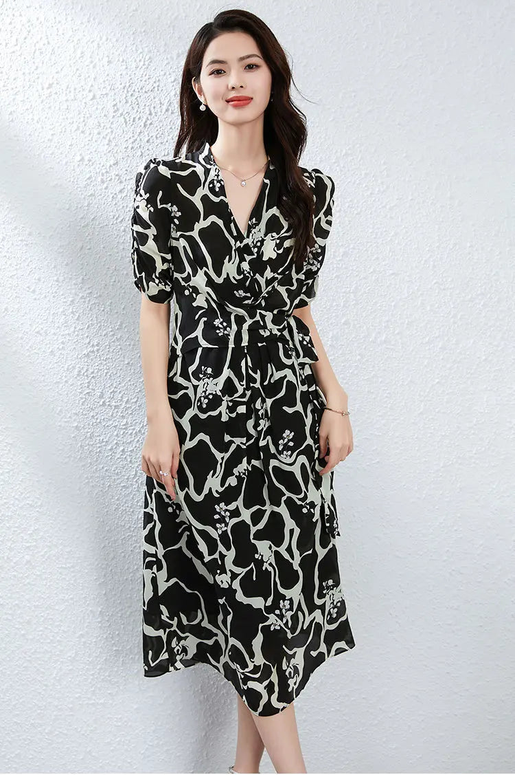 Standing with poise, the model showcases how the box pleats and silk drape elegantly over the legs, revealing the depth of the "unthawed ice" pattern. — From Borcelleclothes.