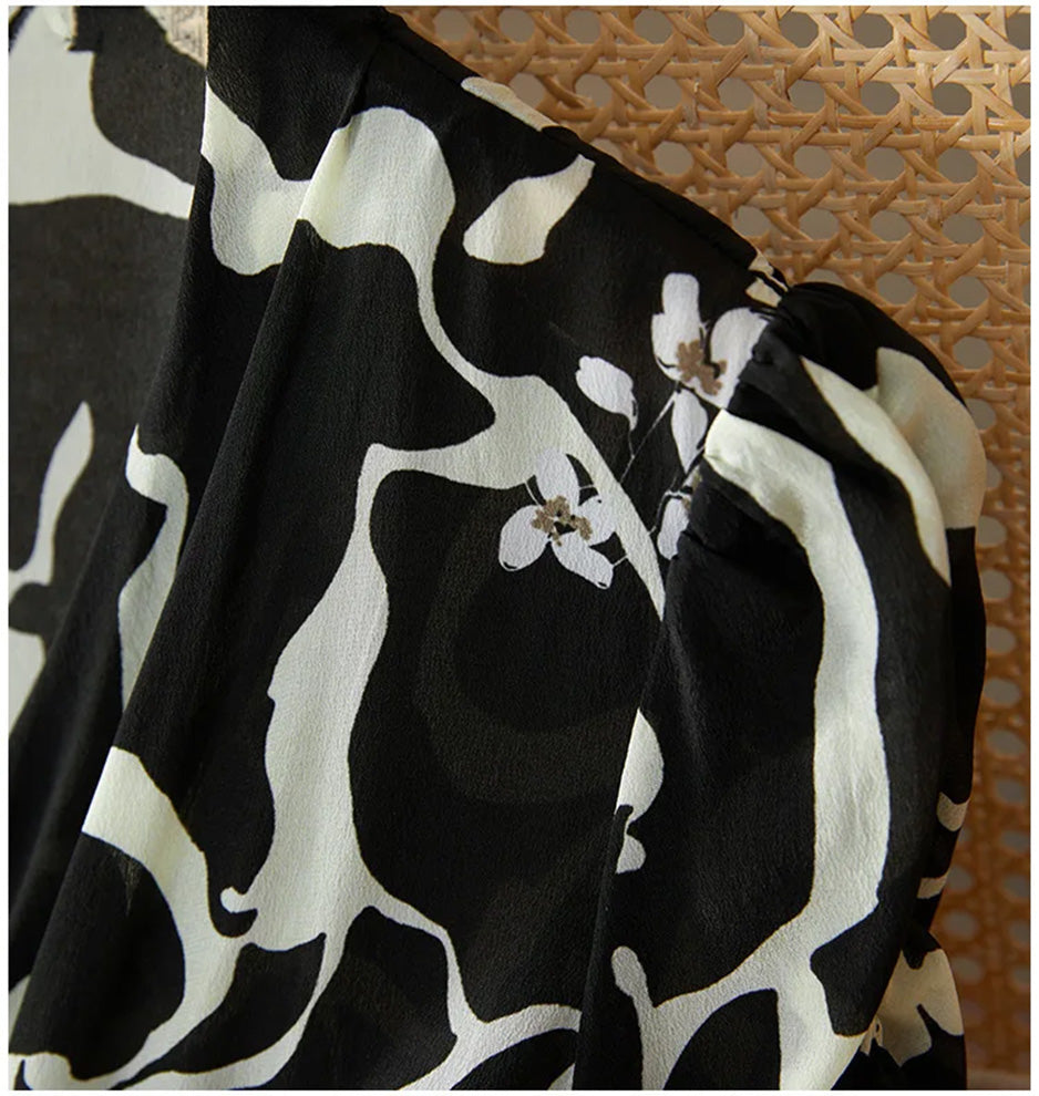 A focus on the sleeve head, showing the slight gathers that give the shoulder a soft but structured look in fine crepe de chine. — From Borcelleclothes.