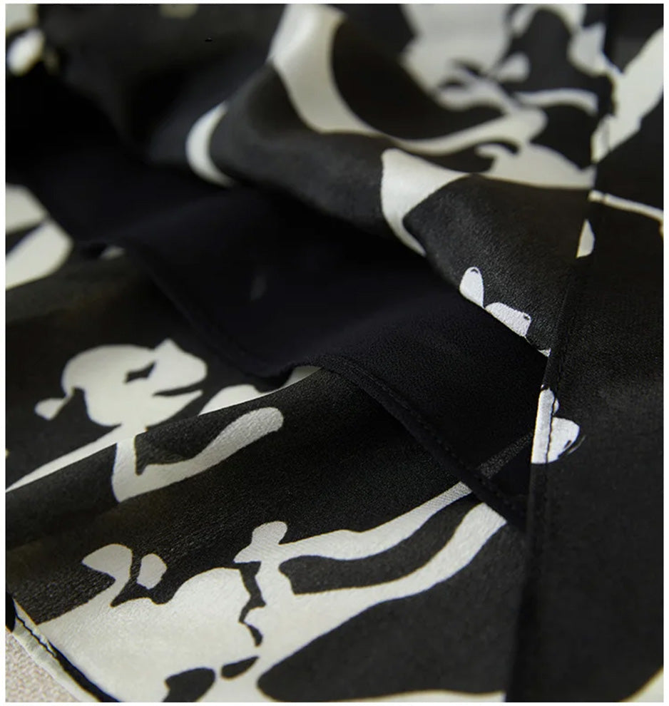A glimpse into the internal quality: the unfolded hem revealing the smooth black lining that ensures the silk dress sits perfectly. — From Borcelleclothes.