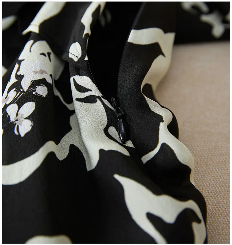 The invisible side zipper partially open, showcasing the professional construction and the inner lining that protects the delicate silk. — From Borcelleclothes.