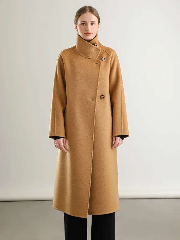 Women's long, wrap-style double-sided wool coat in Camel Train, with an asymmetrical silhouette, saddle sleeves, and a high stand-up collar. — From Borcelleclothes.
