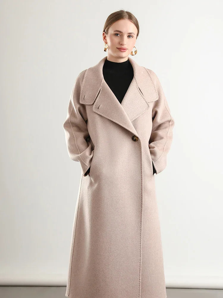 Women's long, wrap-style double-sided wool coat in Sultana Spice, with an asymmetrical silhouette, saddle sleeves, and a high stand-up collar. — From Borcelleclothes.