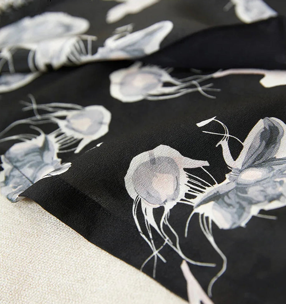 The clean, finished bottom hem of the midi silk dress, showcasing the quality of the double crepe drape — From Borcelleclothes.
