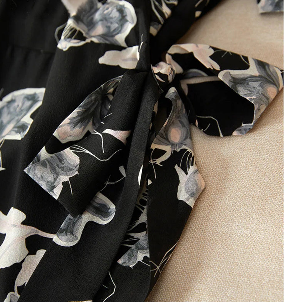 Detail of the silk sashes tied into a delicate bow, securing the wrap design at the waist — From Borcelleclothes.