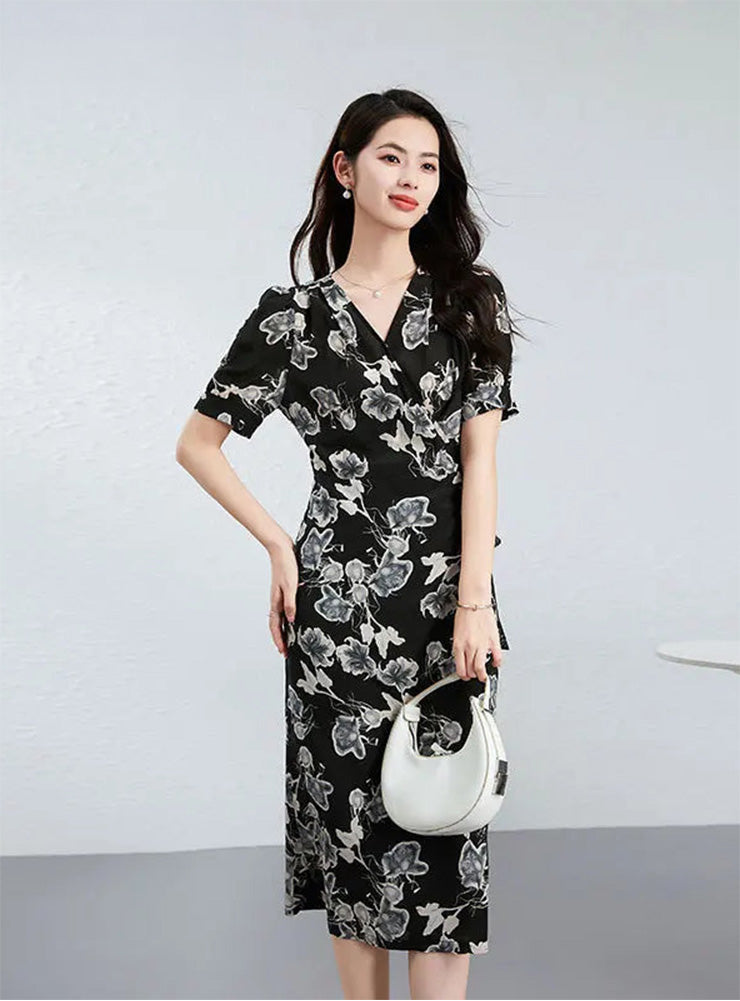 A woman with one hand on her hip holding a bag, showcasing the defined waist and the "Drifting Blossom" design — From Borcelleclothes.