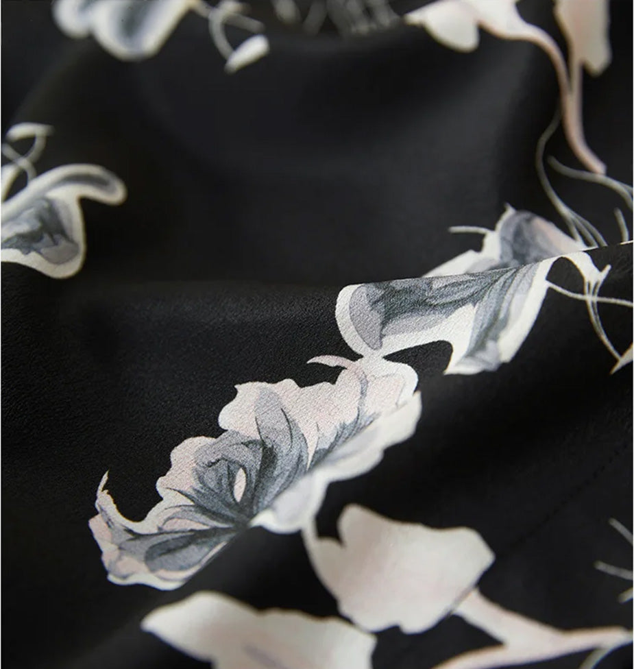 Macro shot of the 100% Mulberry Silk Double Crepe texture, showing the refined grain and "Drifting Blossom" Guohua print — From Borcelleclothes.