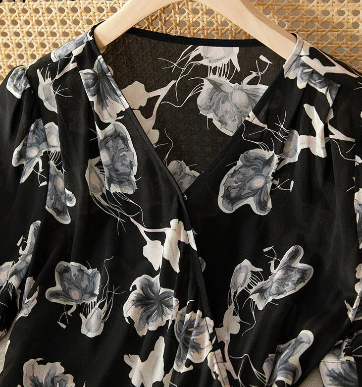 Close-up of the elegant wrap V-neckline, highlighting the precision of the silk finish — From Borcelleclothes.