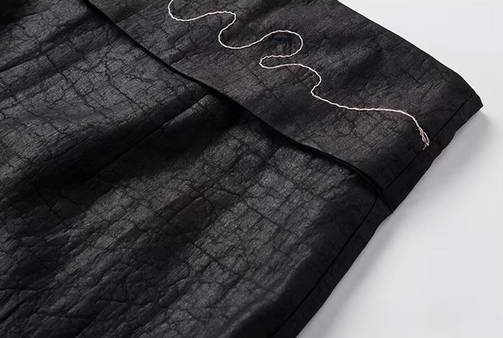 Close-up of the free-floating corner of the embroidered waist panel stitched into the left side seam — From Borcelleclothes.